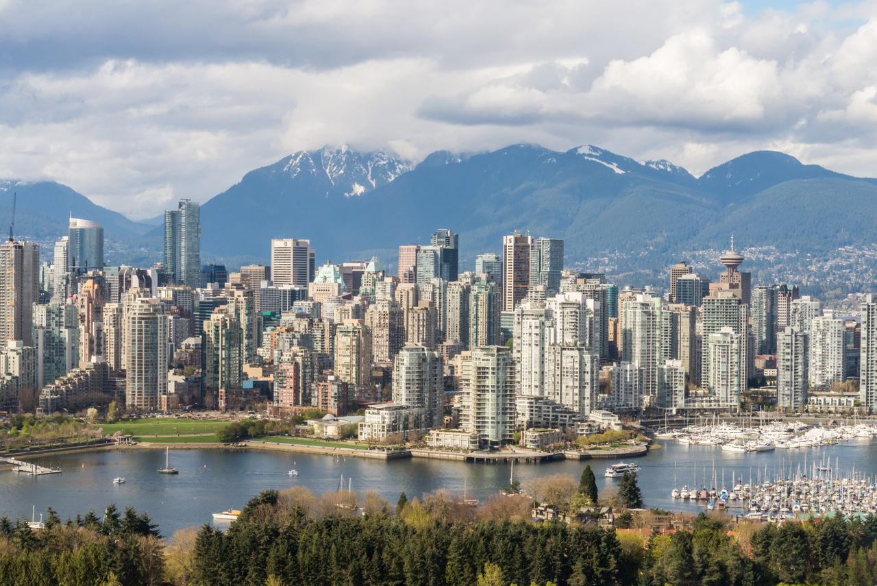 services-03 Stunning view of Vancouver's skyline with mountains and marina in the background.